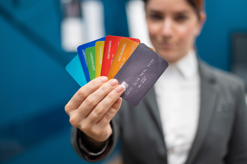 Credit Problems A woman showing a few credit or debit cards