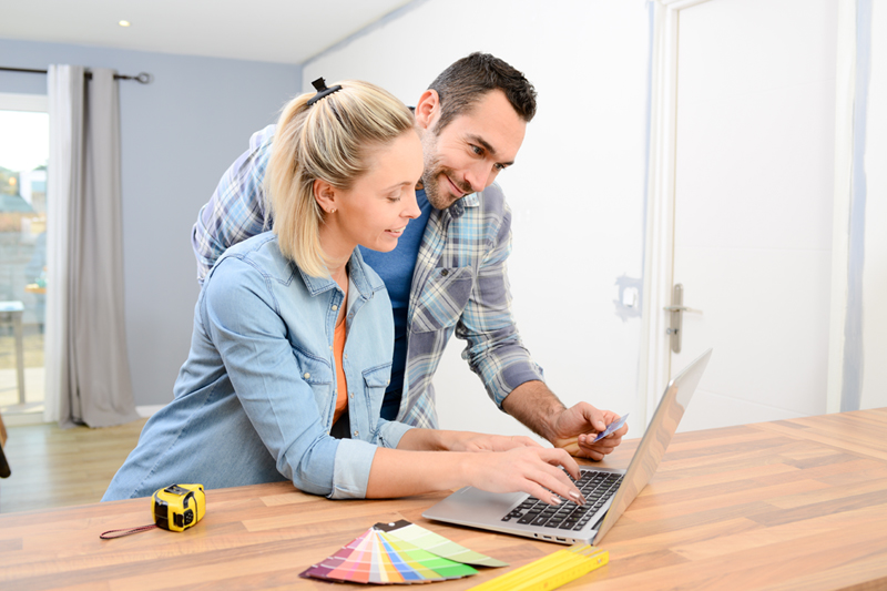 Remortgaging Two people looking at remortgage options on a laptop